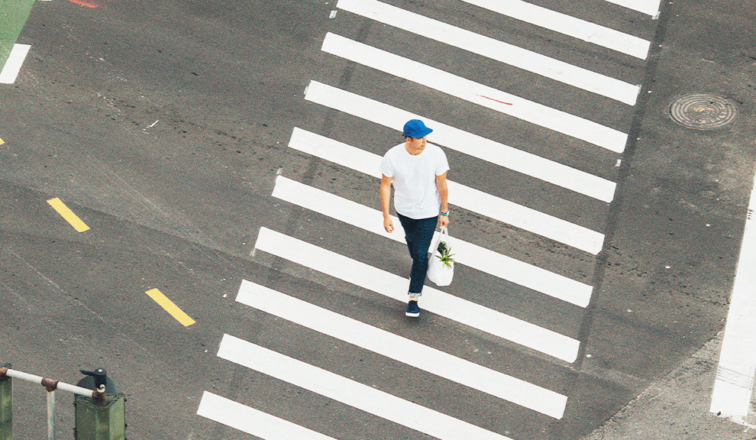 Man walking across crosswalk