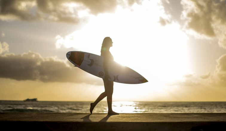 Surfer holding surfboard