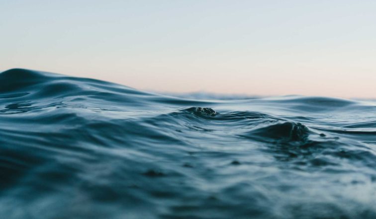 Up-close image of ocean waves during sunset