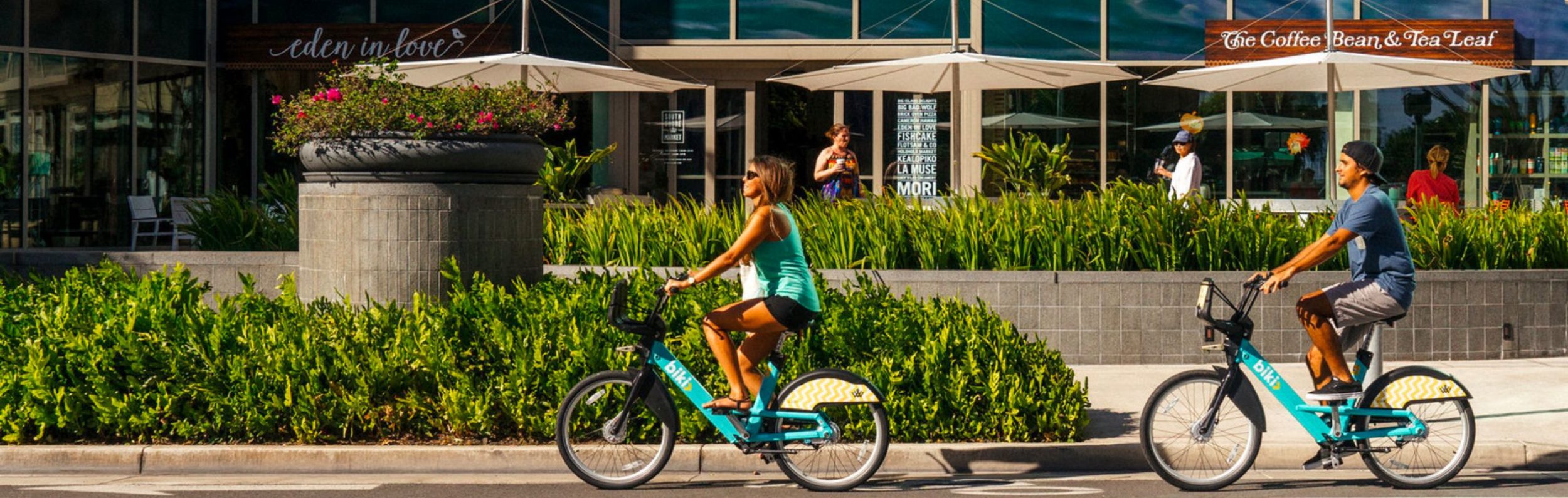 Two people biking around Ward Village