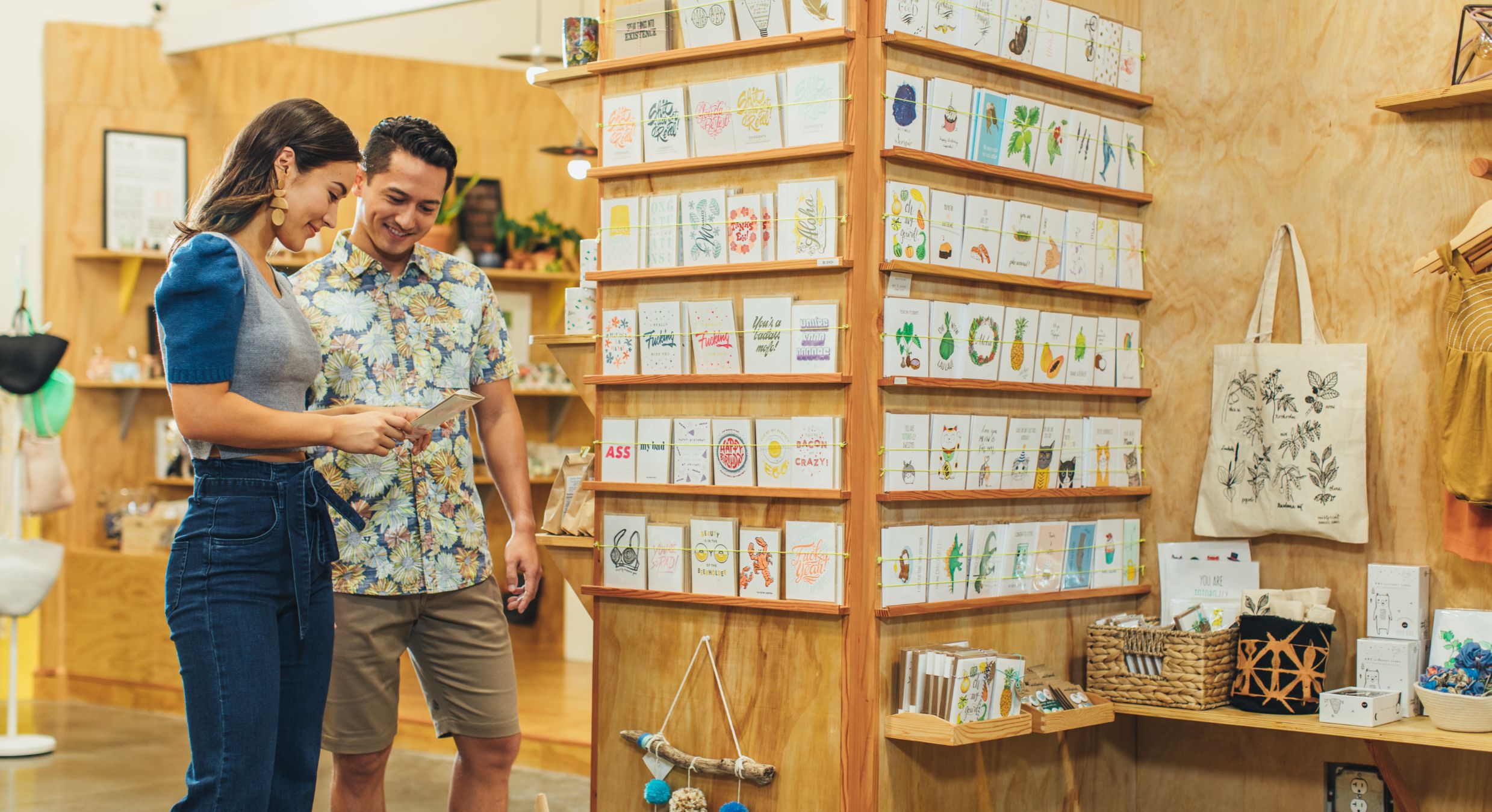 Couple looking at cards at a ward village boutique