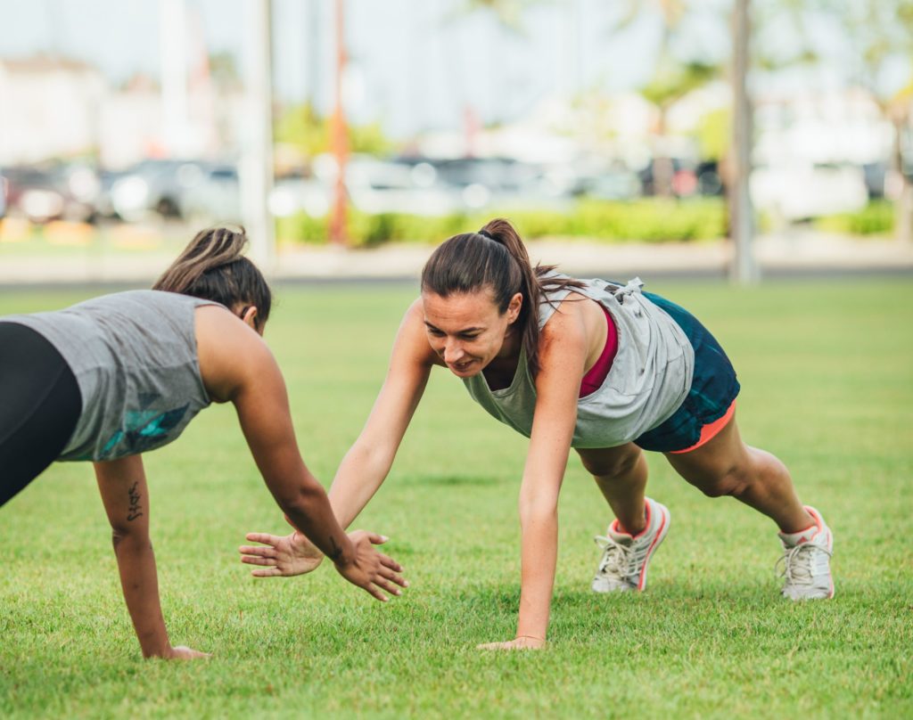 Two women doing push up exercises