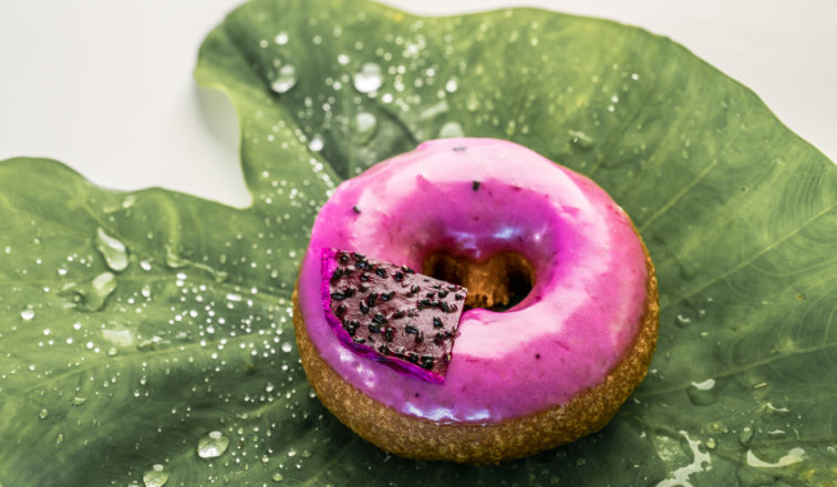 Holey Grail dragonfruit donut sitting on a leaf