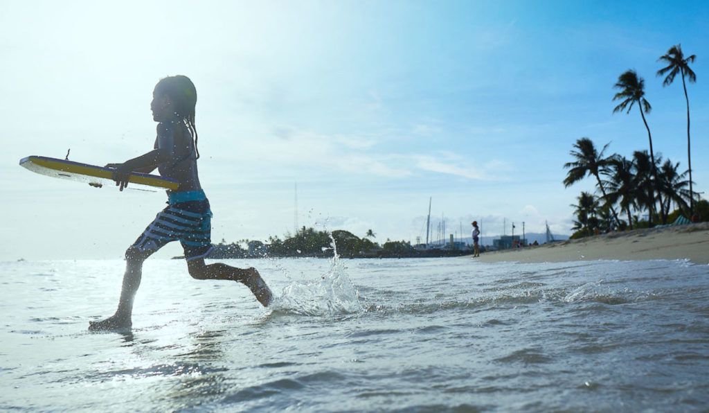 Kid running to the ocean