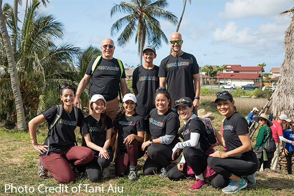 Volunteers gathering to support and help remove invasive plants and species.