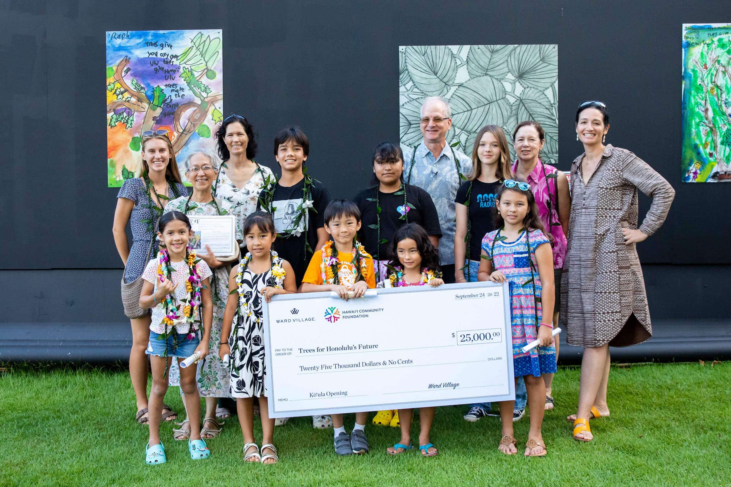 Group of children and adults posing with a check donation for Trees for Honolulu&#039;s Future.