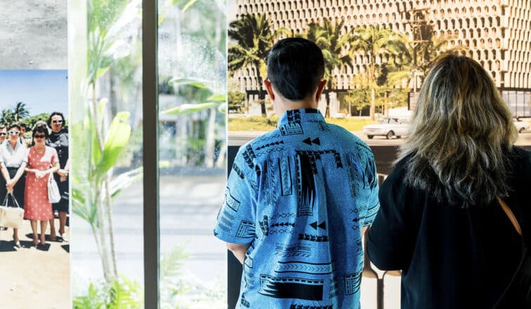 A man and woman admiring the IBM Building photo exhibit.