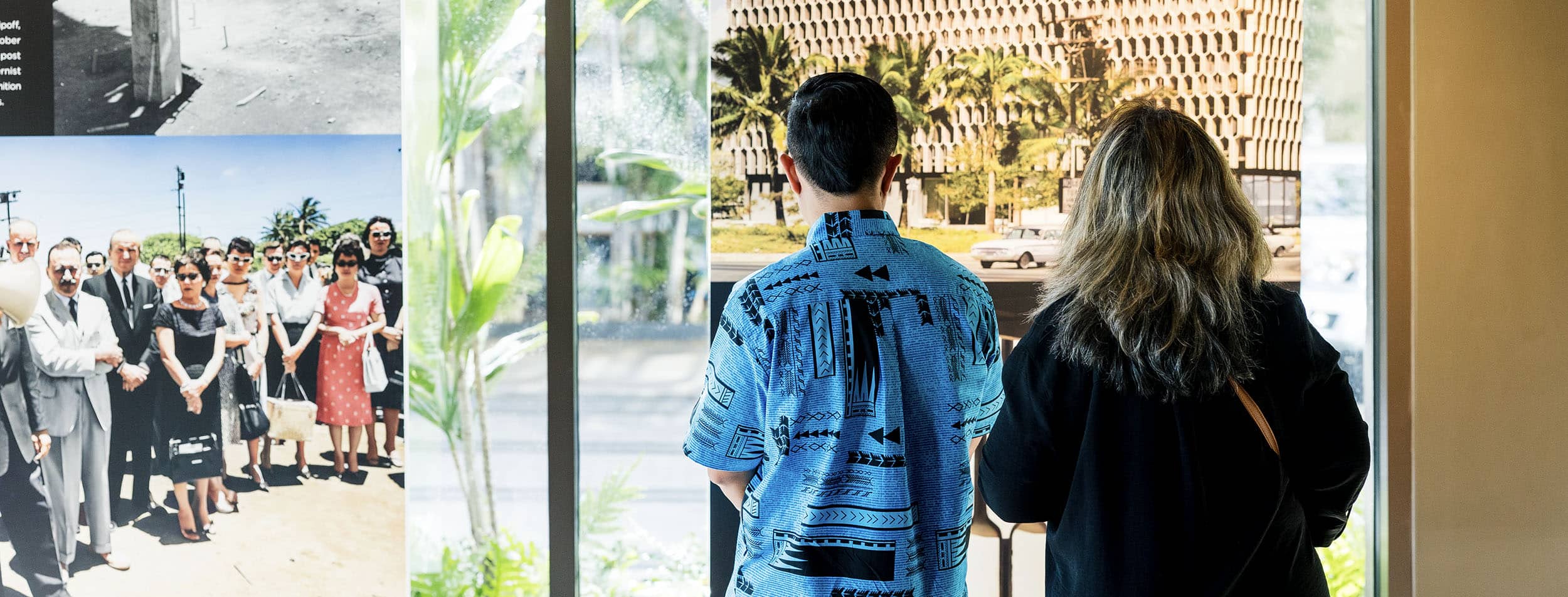 A man and woman admiring the IBM Building photo exhibit.