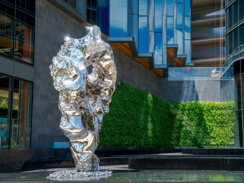 Large silver statue outside of a building