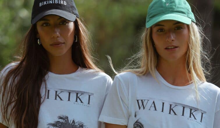 Two women wearing caps and Tshirts